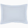 The Cinde Light Indigo Organic Duvet by John Robshaw is a rectangular pillow with a light blue and white patterned cover, featuring a 200 thread count percale with small repeated designs and a flanged edge.