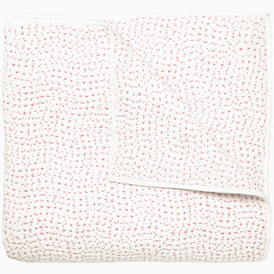 A white and pink Organic Hand Stitched Lotus Quilt with dots, by John Robshaw.