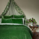 A John Robshaw Velvet Moss Quilt bed with a velvet canopy.