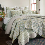 A bed with the John Robshaw Tiya Periwinkle Woven Quilt. - 30395682652206