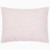 The Organic Hand Stitched Lotus Sham by John Robshaw is a white rectangular pillow sham, hand quilted from organic cotton voile with a soft cotton batting fill. It features a subtle pink stitched dotted-line pattern and a white border.