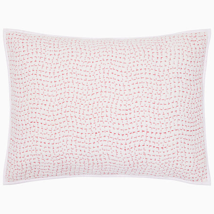 The Organic Hand Stitched Lotus Sham by John Robshaw is a white rectangular pillow sham, hand quilted from organic cotton voile with a soft cotton batting fill. It features a subtle pink stitched dotted-line pattern and a white border.