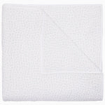 The John Robshaw Organic Hand Stitched Mist Quilt, crafted from soft cotton voile with a subtle woven texture, is shown folded and viewed from above, with one corner partially flipped over.