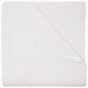 The Organic Hand Stitched White Quilt by John Robshaw features a beautifully textured, white woven design with one corner turned up to reveal its intricate hand stitching on both sides—ideal for layering with organic cotton quilts or other hand-stitched bedding to bring warmth and refined elegance to any bedroom.