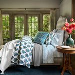A bedroom with blue and white Bilva Peacock Organic Duvet made from John Robshaw organic long staple cotton. - 30784071565358