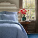 A blue and white bedroom with a Nandi Indigo Quilt bed featuring simple stripes by John Robshaw.