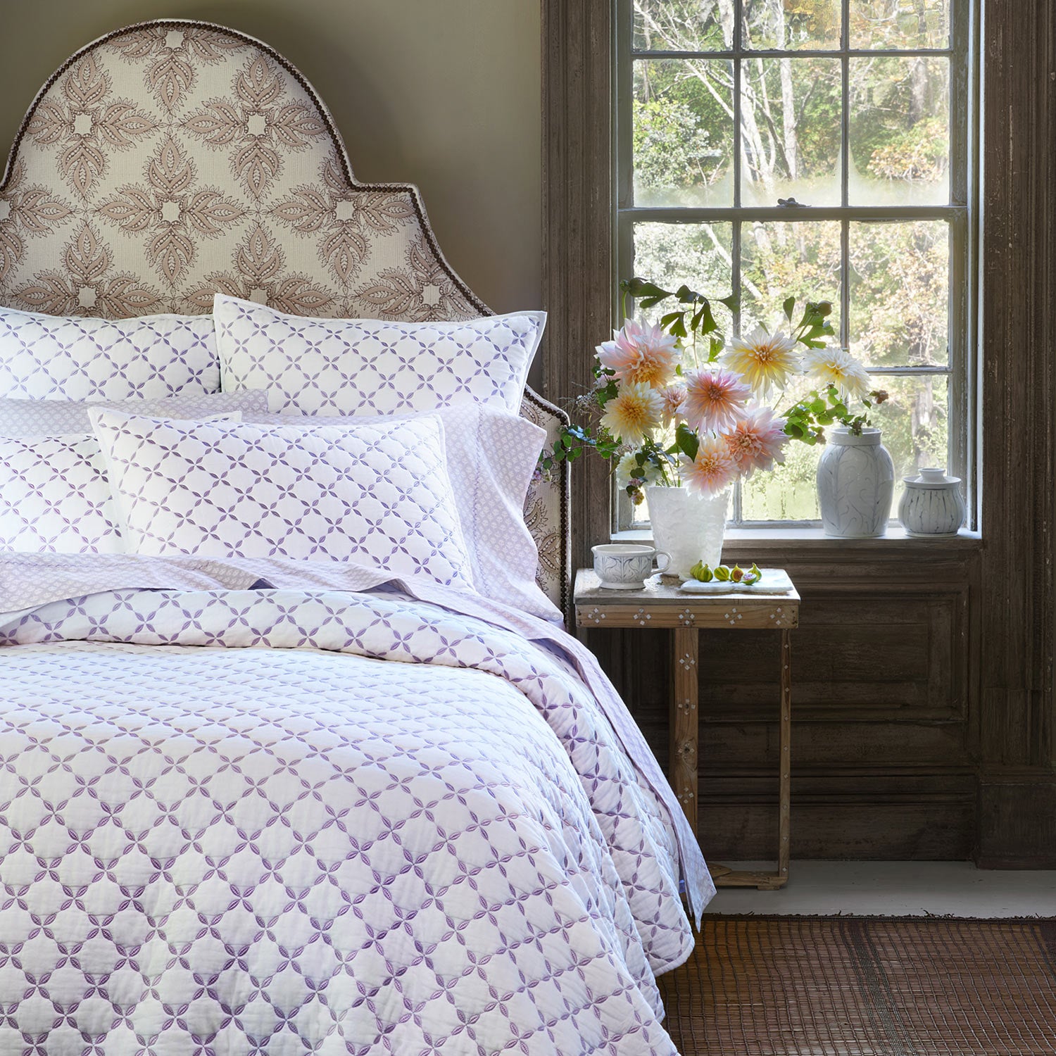 A Layla Lavender Quilt by John Robshaw, made of cotton voile, with a purple and white pattern inspired by Mughal gardens.