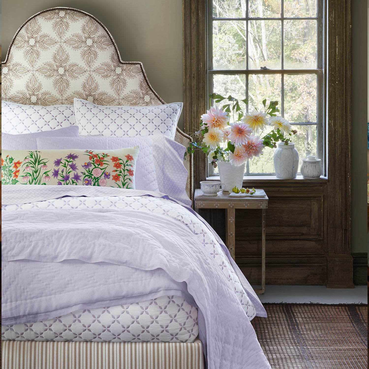 A lavender bedroom with a Bindi Lavender Organic Sheet Set bed and John Robshaw organic pillows.