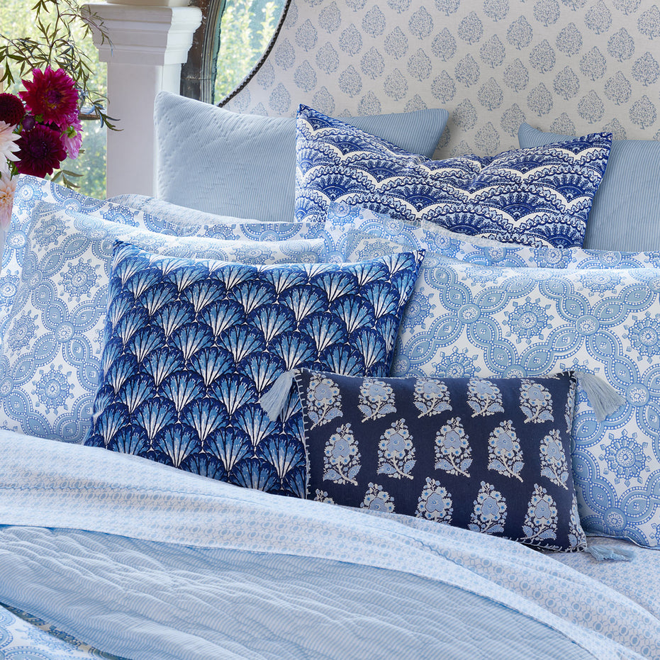 Blue and white Nandi Light Indigo Quilts with block printing on a bed by John Robshaw.