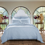 A cotton voile bed with a Nandi Light Indigo Quilt by John Robshaw and arched windows. - 30783856541742