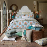 A John Robshaw hand block printed bed with cotton linen and hidden zipper closure, adorned with Lucy Azure Bolster pillows. - 30801454596142