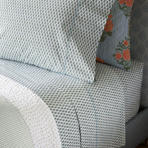A Cala Sage Organic Sheets bed sheet with a blue and white pattern. (John Robshaw)