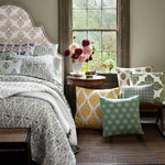 A cozy Dani Euro bed bundled with John Robshaw pillows sits beside a window, where blooms add a touch of natural beauty to the room. - 30801456922670