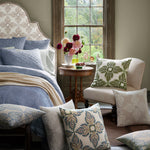 A bedroom with a hand block printed bedspread, John Robshaw Verdin Lapis Decorative Pillows, and a window. - 30801459773486