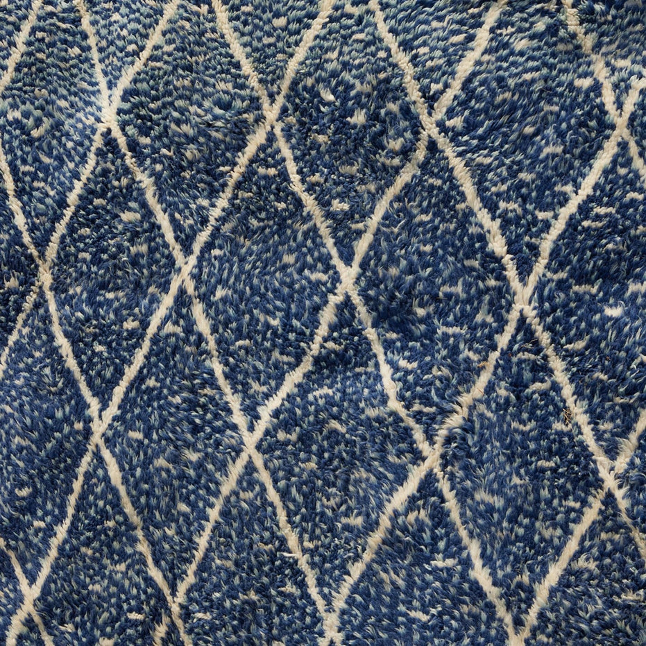 Blue Village 2 Wool Rug in blue with a textured surface and a white diamond lattice design.