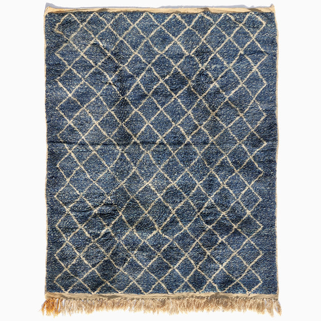 Blue Village Wool Rug with a white diamond pattern, rectangular shape, and fringed ends.