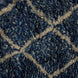 Close-up of a shaggy, handwoven John Robshaw Blue Village Wool Rug featuring a blue and white diamond pattern.
