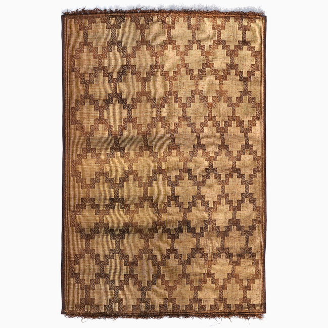 John Robshaw Tazarine Tuareg Mat with a handwoven, repeating brown geometric diamond pattern and fringed top and bottom edges.