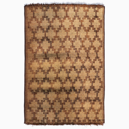 John Robshaw Tazarine Tuareg Mat with a handwoven, repeating brown geometric diamond pattern and fringed top and bottom edges.
