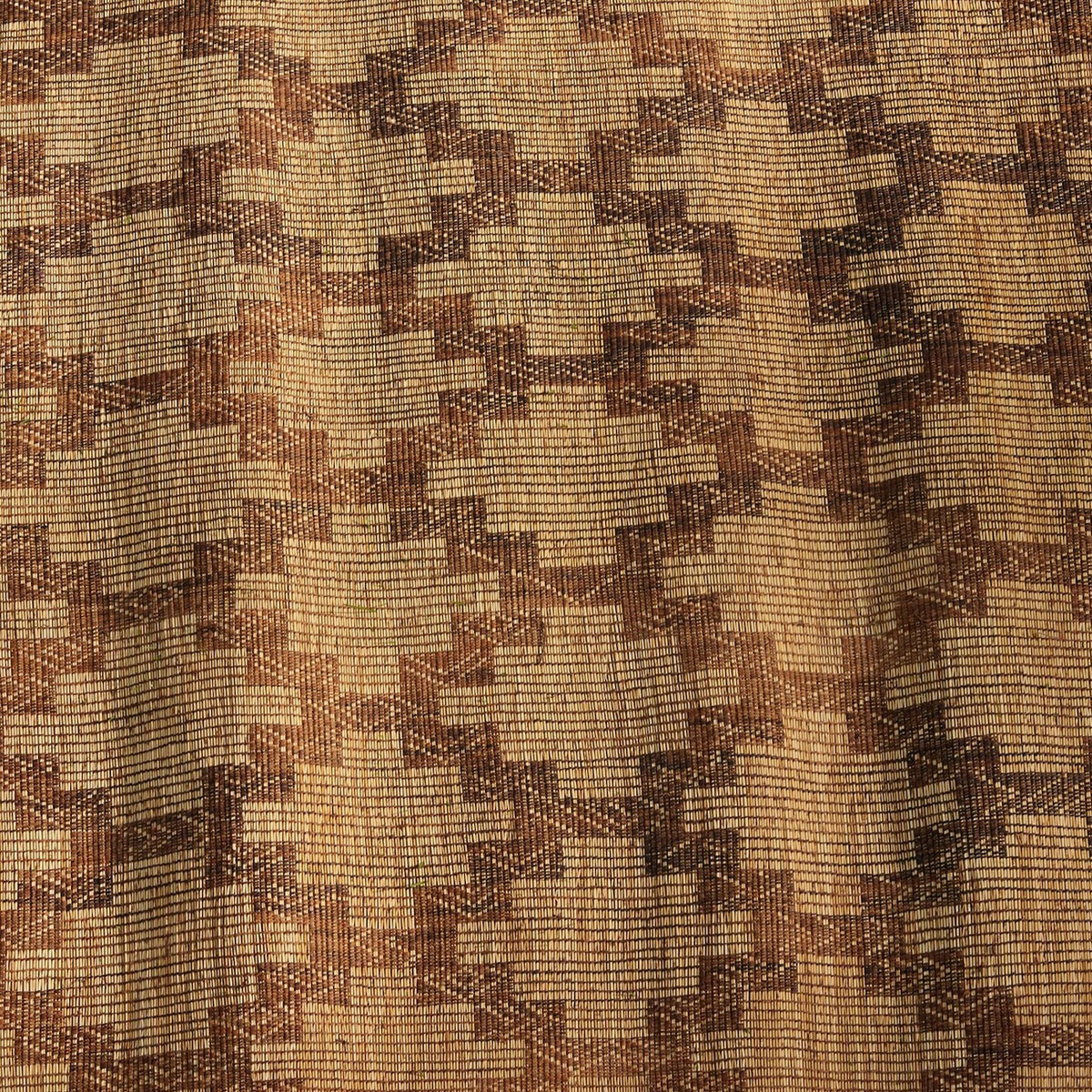 John Robshaw Tazarine Tuareg mat featuring a handwoven, repeating brown and tan geometric stepped pattern.