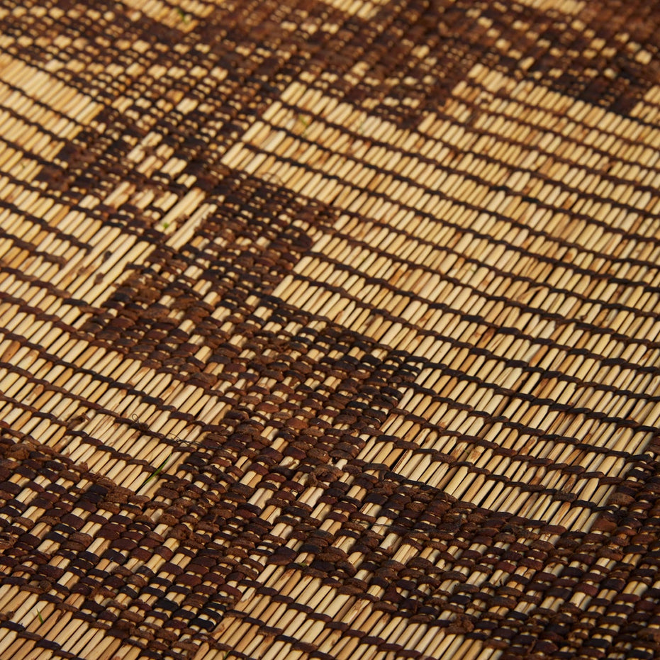 Handwoven Tazarine Tuareg Mat featuring a geometric pattern in light and dark brown reeds.