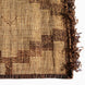 John Robshaw Tazarine Tuareg Mat with a brown geometric pattern, dark leather border, and fringed edge.