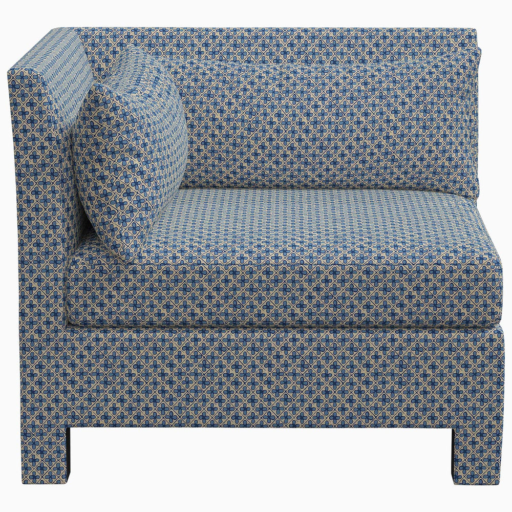 The John Robshaw Sameera Armless Chair is a stylish blue corner chair featuring an exclusive patterned fabric. This custom seating arrangement adds a touch of elegance to any space.