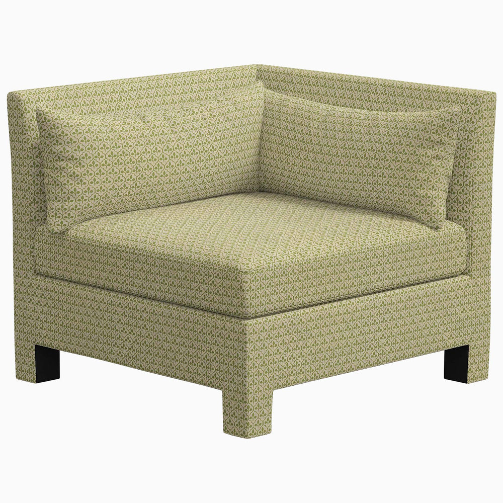 The John Robshaw Sameera Corner Chair is a custom seating arrangement featuring exclusive fabrics with a pattern, exuding an elegant green aesthetic.