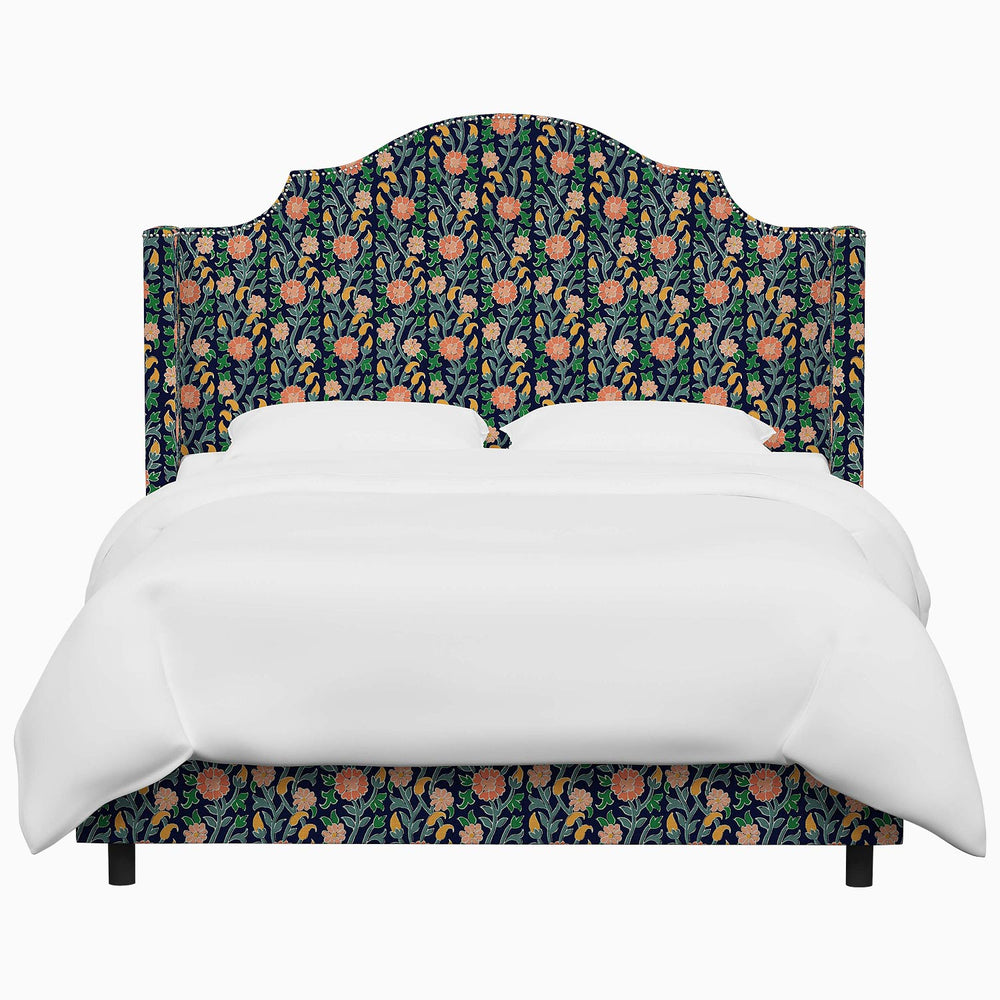 The John Robshaw Samrina bed features a floral upholstered headboard and footboard, inspired by Mughal arches.