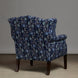 The Ashi Azure Woodruff Chair by John Robshaw is upholstered in elegant Ashi Azure fabric with traditional block print-inspired motifs, features dark wooden legs, and is shown facing away from the camera against a plain background.