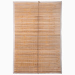 The Lapis Chik Blinds by John Robshaw Textiles feature a rolled-out bamboo mat with white edging, displaying parallel horizontal slats linked by vertical strings, reminiscent of Indian chik blinds. - 31884733612078