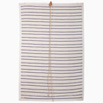 A rectangular blanket with indigo stripes and a central brown leather strap, echoing the intricate patterns of John Robshaw Textiles' Lapis Stripe Chik Blinds. - 31884734038062