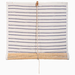 The Lapis Stripe Chik Blinds by John Robshaw Textiles features horizontal navy and white stripes, reminiscent of traditional chiks. They roll up partially on a bamboo rod and are secured with a center vertical cord. - 31884734070830