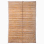 A rectangular bamboo window shade with thin horizontal slats and a light border, reminiscent of traditional Indian chik blinds, describes the Maanika Chik Blinds by John Robshaw Textiles. - 31884734726190