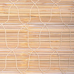 A close-up of the Maanika Chik Blinds by John Robshaw Textiles showcases a woven bamboo mat with intersecting curved lines. The textured grid pattern in natural brown tones enhances the rustic elegance of these traditional Indian blinds. - 31884734758958