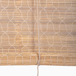 Close-up of a Bamboo Chik Blind by John Robshaw Textiles, showing a light wood finish with a white string pattern, partially rolled up, and a central hanging cord. - 31884735348782