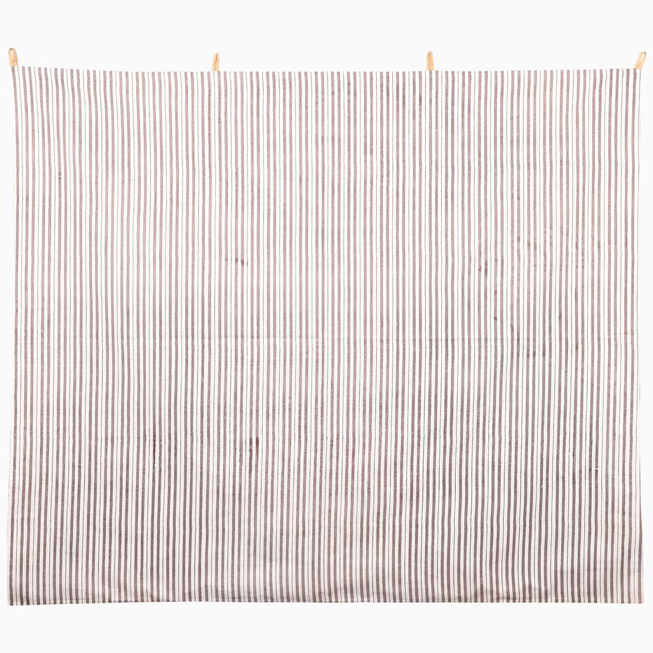 We Gallop Tapestry featuring a rectangular wall hanging of vertical brown and white stripes, suspended from wooden clips as cattle wall art.