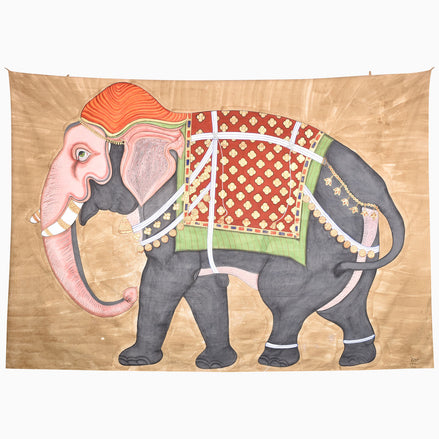 A Back This Way Tapestry featuring a grey elephant adorned with an orange headpiece and an ornate red and green patterned embroidered jhool.