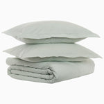 A stack of John Robshaw's Cinde Sage Organic Duvet pillows on top of each other. - 30768957915182