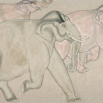 A hand-painted Elephants En Route Lumbar Pillow of three elephants walking in a field on cotton linen fabric with a hidden zipper closure, by John Robshaw. - 30801478975534