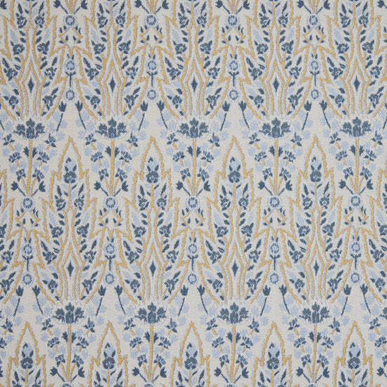 A blue and yellow floral pattern on a white background inspired by the Mughal gardens of Shalimar Bagh, featuring the Marmar Marigold Performance Fabric by John Robshaw.