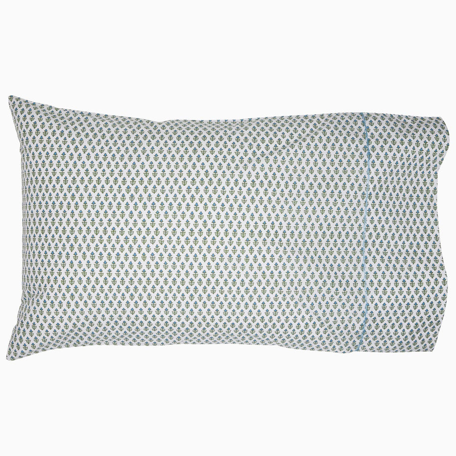 A Cala Sage Organic Sheets pillow with a geometric pattern by John Robshaw.