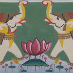 Two stylized elephants facing each other with raised trunks, surrounding a large pink lotus flower, on a green and white background, reminiscent of the hand-painted Shanta Kidney Pillow by John Robshaw made in India. - 31263498928174