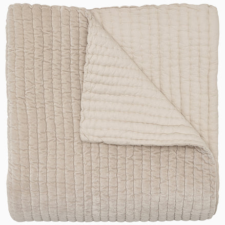 A soft, beige Velvet Sand Quilt by John Robshaw on a white background.