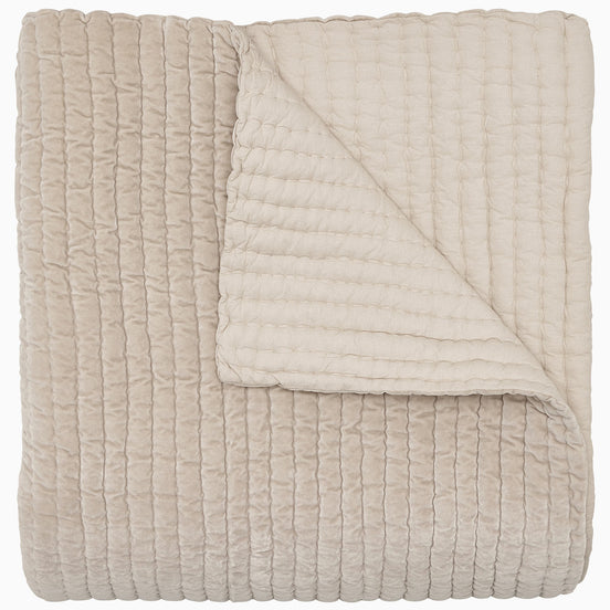 A soft, beige Velvet Sand Quilt by John Robshaw on a white background.