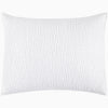 An Organic Hand Stitched White Quilt from John Robshaw with a cotton voile coverlet.