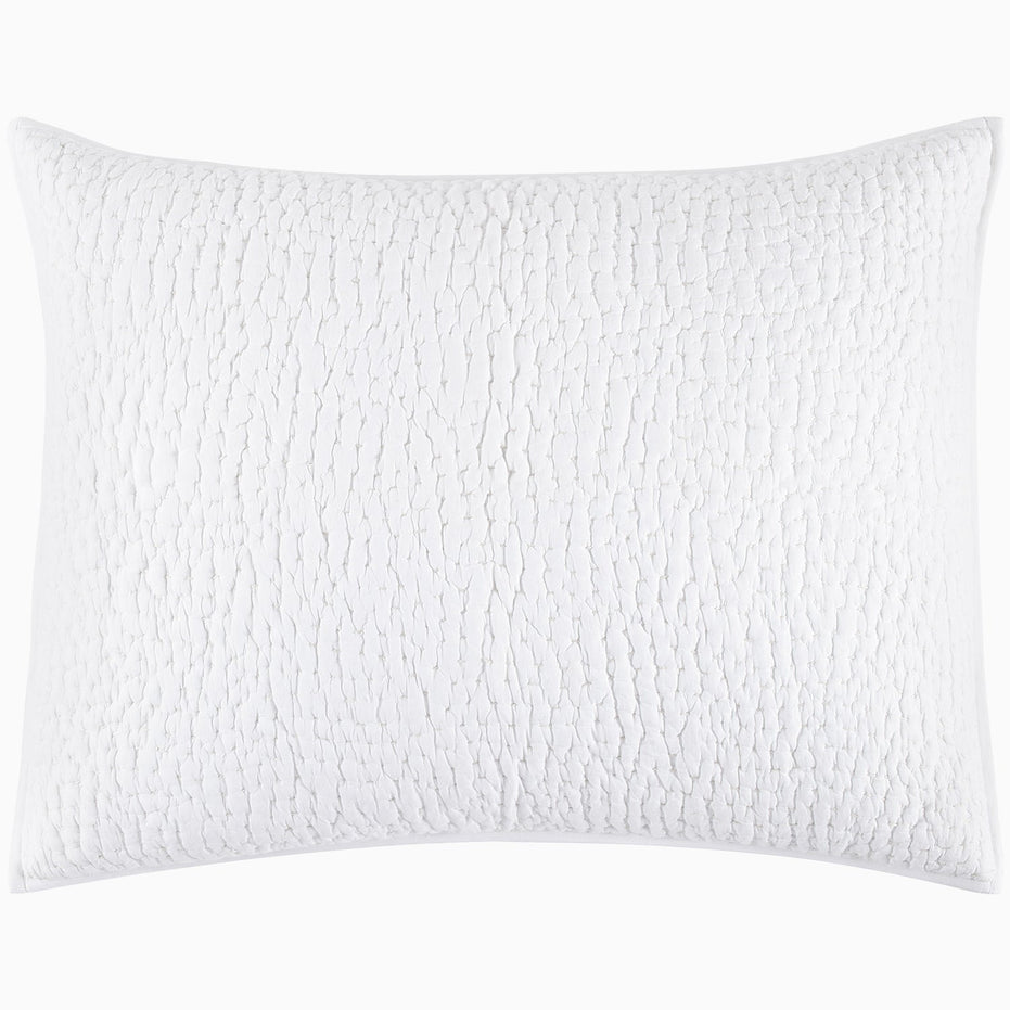 An Organic Hand Stitched White Quilt from John Robshaw with a cotton voile coverlet.