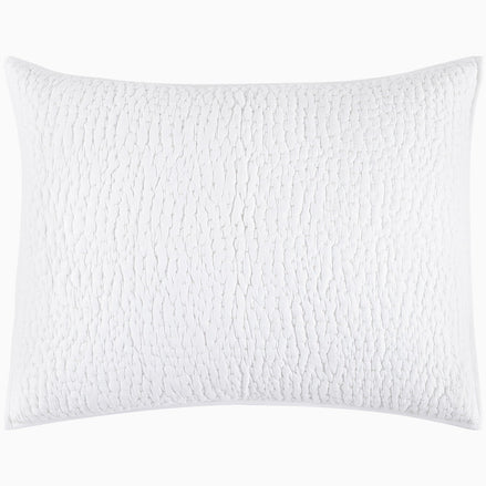 An Organic Hand Stitched White Quilt from John Robshaw with a cotton voile coverlet.