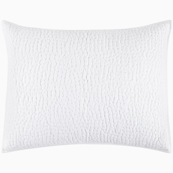 An Organic Hand Stitched White Quilt from John Robshaw with a cotton voile coverlet.