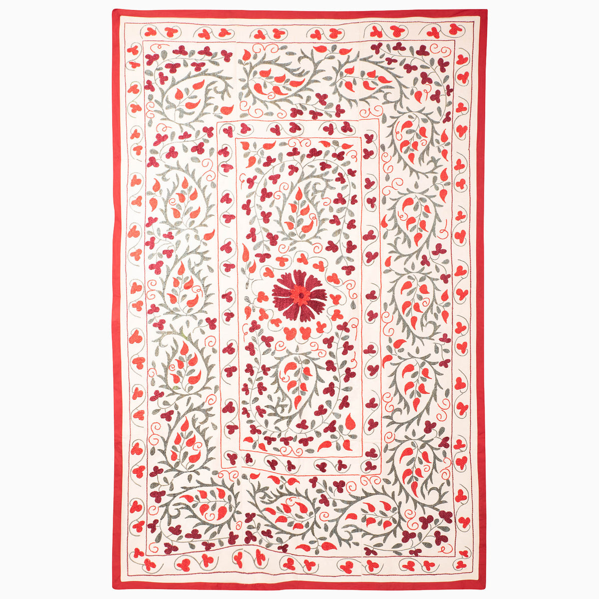 John Robshaw Come Along Then Suzani blanket in cream with a red border and an embroidered pattern of red and grey floral vines surrounding a central flower.